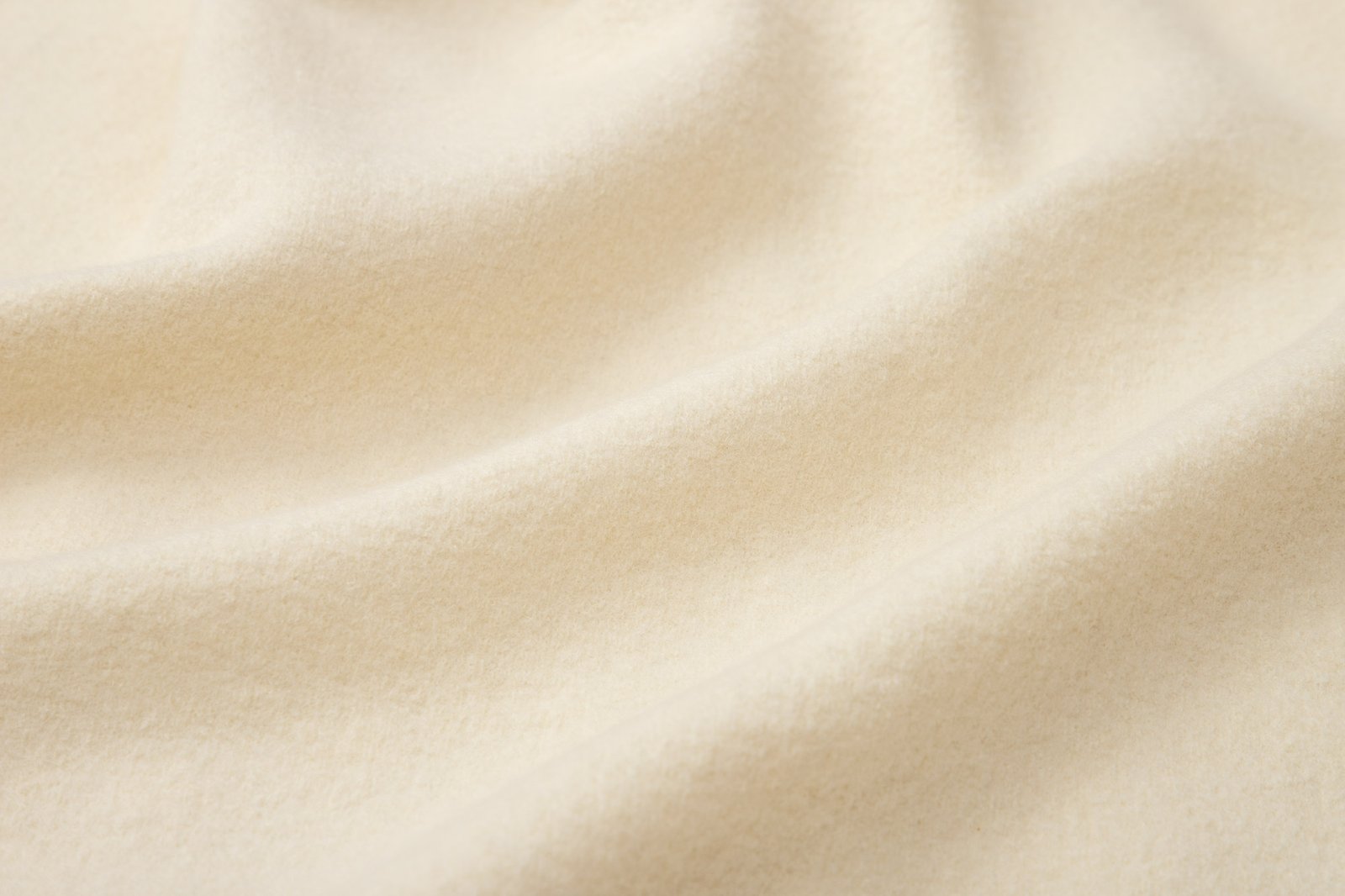 Cream wool fabric draped in soft folds