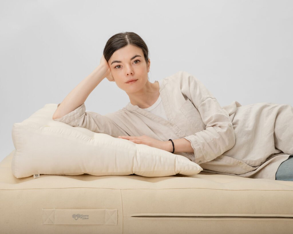 Wool wedge pillow in natural cotton casing