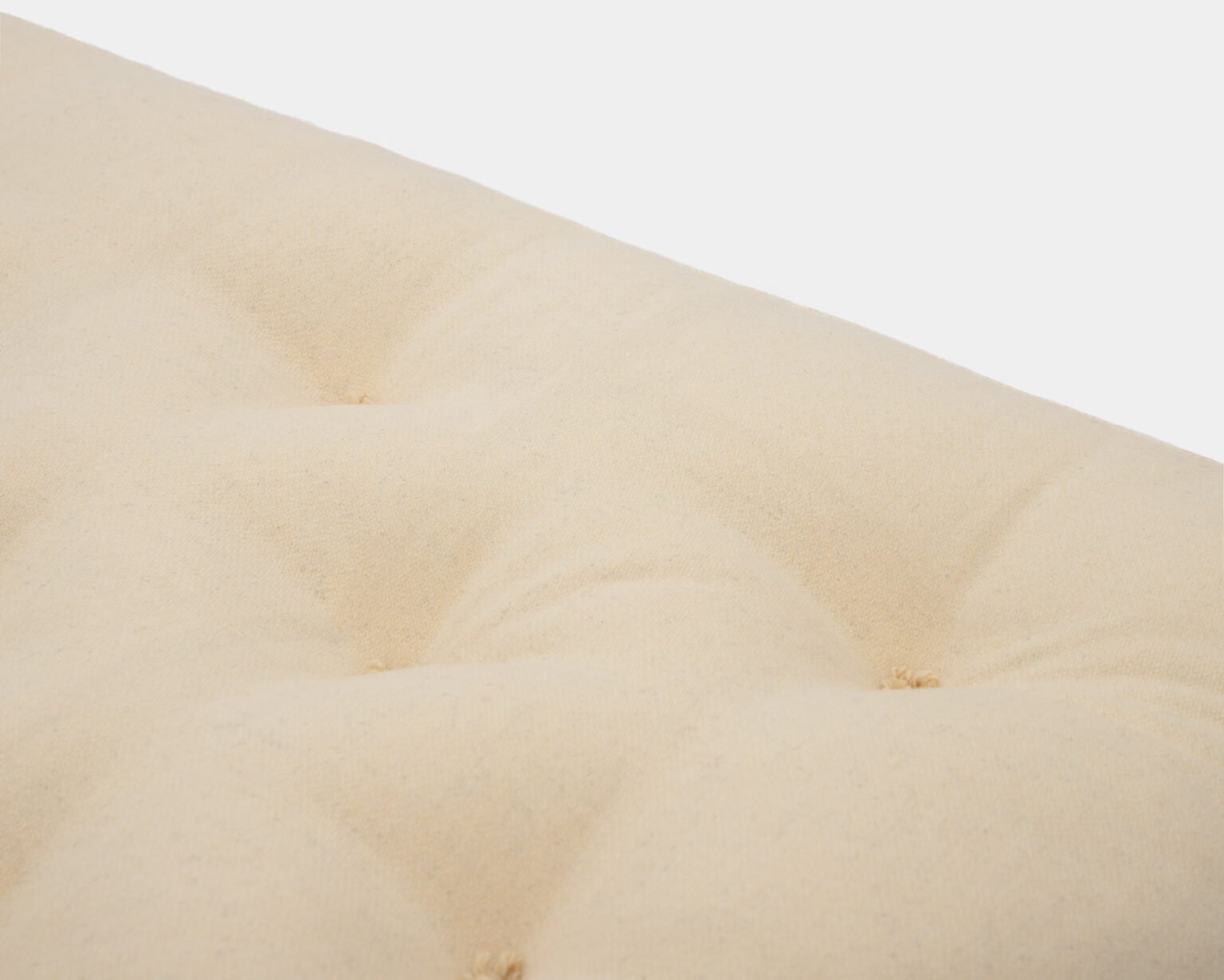 Hand-tufting stitch detail on a wool mattress